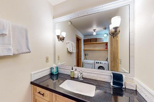 a bathroom with a sink and a large mirror at Viking Lodge B218 in Telluride