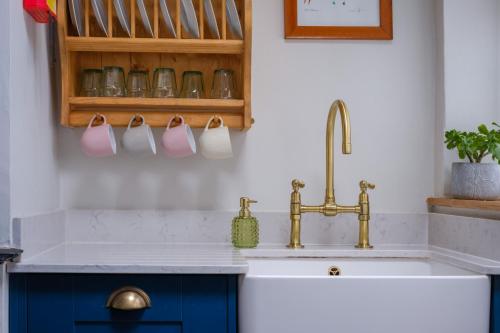 a kitchen with a sink and a faucet at Fellfoot Cottage in the Lake District in Staveley