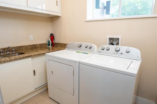 a white washer and dryer in a kitchen at Disney Escape Modern 3BR Townhouse 2 Miles to the Parks 4 Baths in Orlando