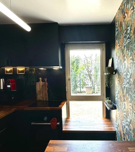 une cuisine avec une fenêtre et un comptoir de cuisine dans l'établissement La Galerie - appartement entier -75 m2, à Noisy-le-Grand
