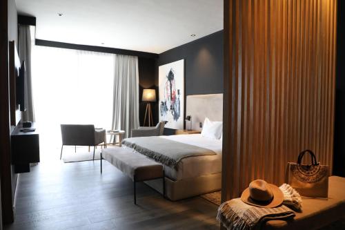 a hotel room with a bed and a table with a hat on it at Puesto del Indio in Mendoza