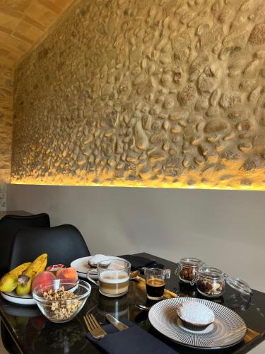 a table with plates of food and drinks on it at Gaeta Rooms in Lanciano