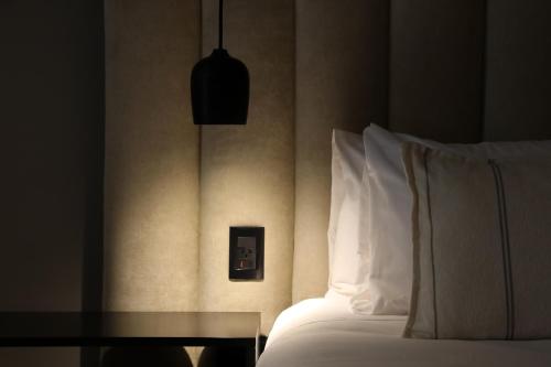 a bedroom with a bed with pillows and a table at Puesto del Indio in Mendoza