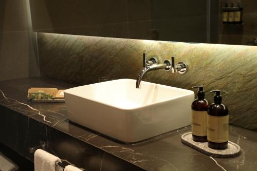 a bathroom sink with two bottles of wine on a counter at Puesto del Indio in Mendoza