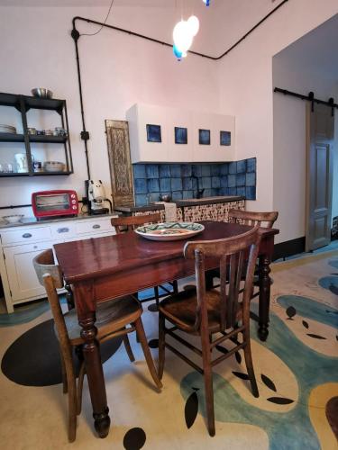 a kitchen with a wooden table and chairs at Dimora Vicolo Leoncini in Tivoli