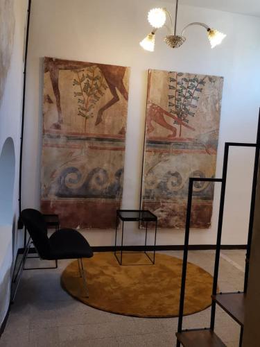 a room with two chairs and a painting on the wall at Dimora Vicolo Leoncini in Tivoli
