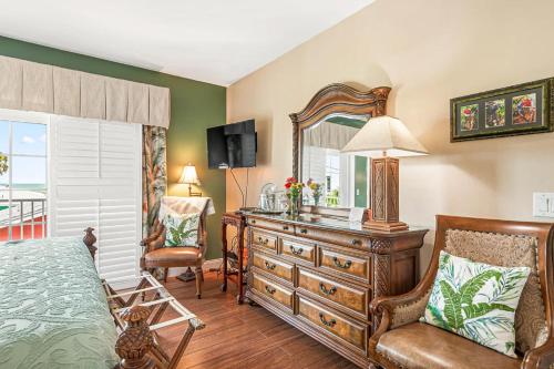 a bedroom with a dresser and a mirror at Windemere Inn by the Sea in Melbourne