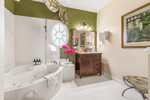 a bathroom with a tub and a large clock on the wall at Windemere Inn by the Sea in Melbourne