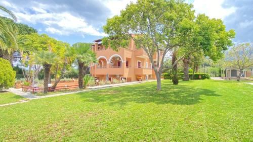 a large house with a lawn in front of it at Villa Pami in Almiros Beach