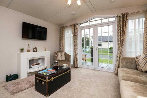 a living room with a couch and a fireplace at Stylish and cozy holiday home in Carnforth