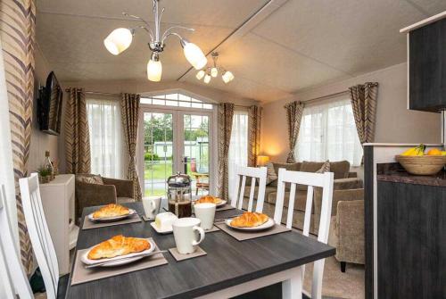 a dining room table with plates of food on it at Stylish and cozy holiday home in Carnforth