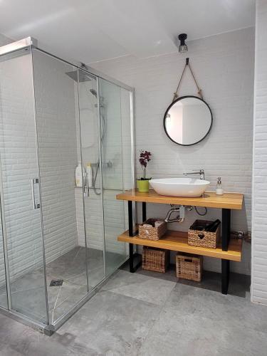 a bathroom with a glass shower and a sink at Mazagón Pez de Plata in Mazagón