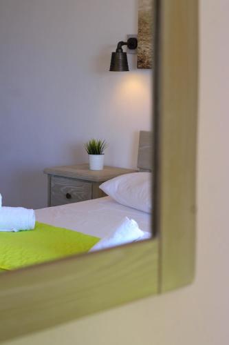 a mirror reflection of a bed in a bedroom at Mistral-Patmos in Patmos