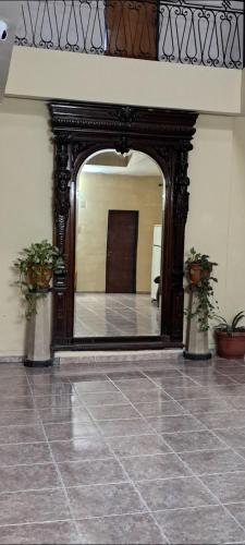 a large mirror in a room with a tile floor at Hotel La Giralda in Buenos Aires