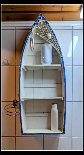 a shelf in a kitchen with a bottle on it at Apartment da Luiz Salvatore in Wurmlingen