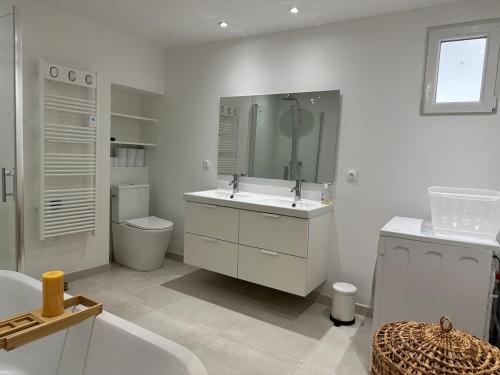 une salle de bain blanche avec un lavabo et des toilettes dans l'établissement Appartement panoramique, clim, terrasse, 6 personnes, à Lacoste