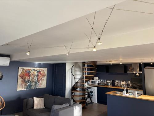 un salon avec un canapé et une cuisine dans l'établissement Les nuitées de larlesienne, à Saint-Michel-Loubéjou