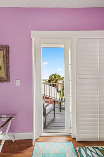 a room with a door open to a deck at Windemere Inn by the Sea in Melbourne