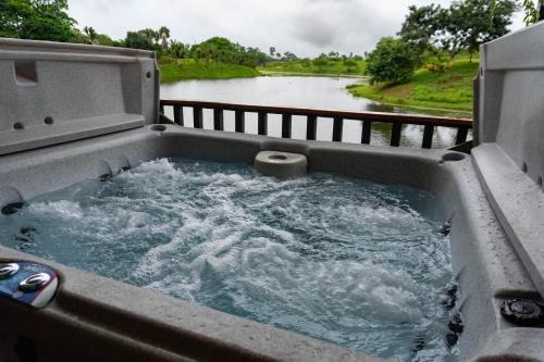 a hot tub with water in it next to a river at Hotel Ecopaisajes- Lake-Premier-Resort in Quesada