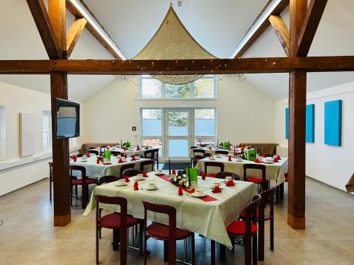 a room with tables and chairs in a building at Haus Rosenbaum Gruppenhaus- Begegnungsstätte - Pension in Neuhaus am Rennweg