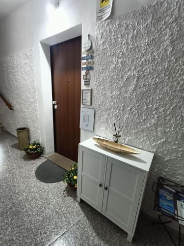 a bathroom with a sink and a brown door at Bed and breakfast Raggio di Sole in Iglesias