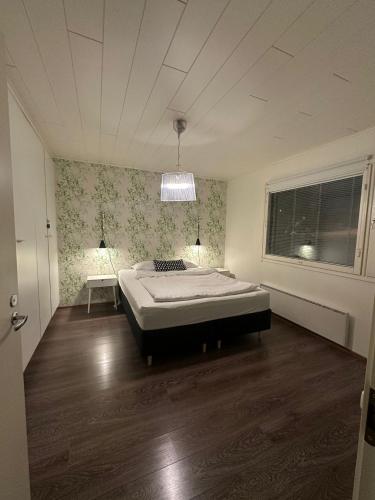 a bedroom with a bed in the middle of the room at River landscape close to the centre, Himos 8km in Jämsä