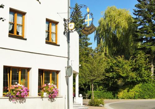 ein Straßenlicht vor einem weißen Gebäude in der Unterkunft Hotel Gasthof Kreuz in Bad Buchau