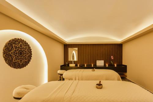 a spa room with two beds and a mirror at Fiesta Americana Hacienda San Antonio El Puente Resort & Spa in Cuernavaca