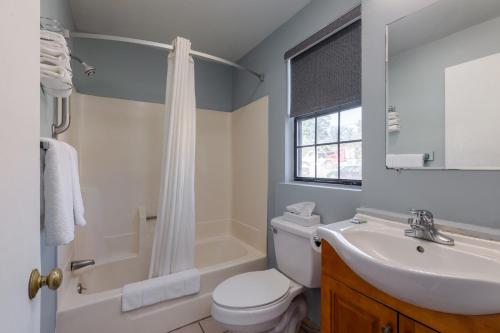 a bathroom with a sink and a toilet and a shower at Knights Inn North Attleboro in North Attleboro