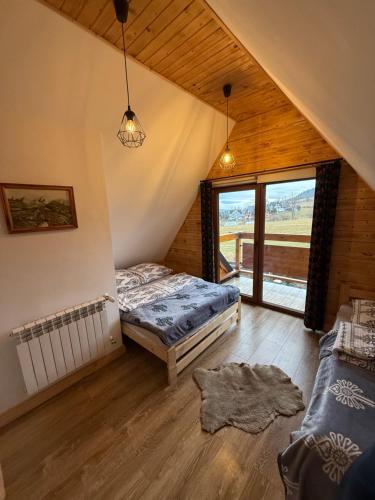 a bedroom with two beds in a attic at Domki na Stoku in Czarna Góra