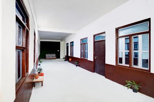 an empty hallway of a building with windows at SPOT ON Hotel Lakshya Ghatampur in Kānpur