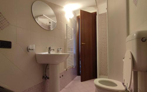 a bathroom with a sink and a toilet and a mirror at Sunnyhill Home in Monterotondo