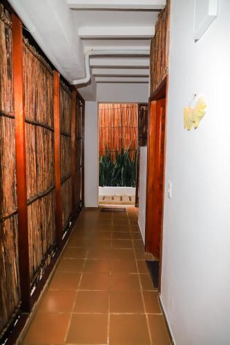 a hallway with wood panels on the walls at Hostal Casa en la Ciénaga Rincon del Mar in Rincón