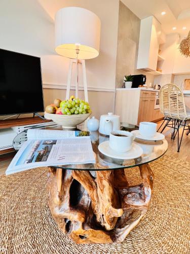 a coffee table made out of a log with fruit on it at Rezydencja Niechorze MORSKIE WIDOKI 313 z Basenem i SPA - 5D Apartments in Niechorze