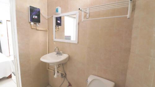 a bathroom with a sink and a toilet and a mirror at Mezcales Inn in Mezcales