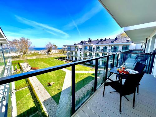 a balcony with a table and a view of a building at Rezydencja Niechorze MORSKIE WIDOKI 313 z Basenem i SPA - 5D Apartments in Niechorze