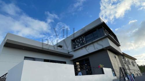 a large white house with a sky in the background at Villa Palmeras - 4 Bedrooms AC Modern Luxury Villa in Phoenix