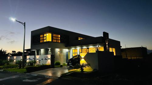 a house with its lights on in front of it at Villa Palmeras - 4 Bedrooms AC Modern Luxury Villa in Phoenix