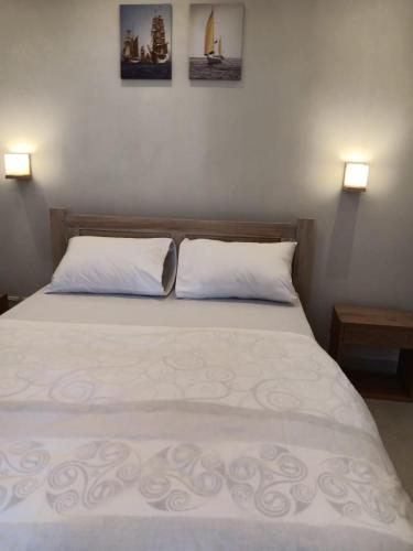 a bedroom with a large bed with two pillows at Villa Palmeras - 4 Bedrooms AC Modern Luxury Villa in Phoenix