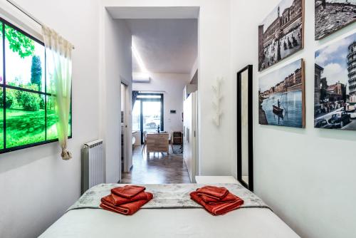 a bedroom with a bed with red towels on it at Orlando's House - Pisa Downtown with View in Pisa