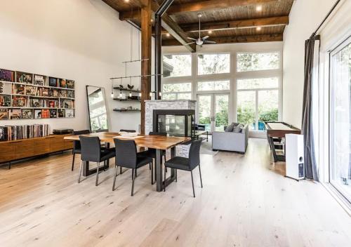 a dining room with a table and chairs and a fireplace at Large Modern Home in Squamish in Squamish