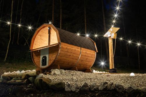 a wooden boat sitting on the ground at night at AL RANCH WELLNESS CADORE DOLOMITI APARTMENTS vicino Cortina Olimpiadi 2026 e Misurina Tre Cime Lavaredo in Pieve di Cadore