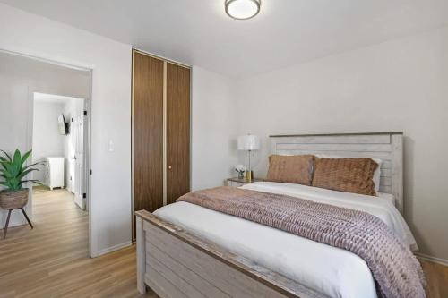 a bedroom with a large bed with a wooden headboard at Tranquil Getaway for the Entire Family in Westmont