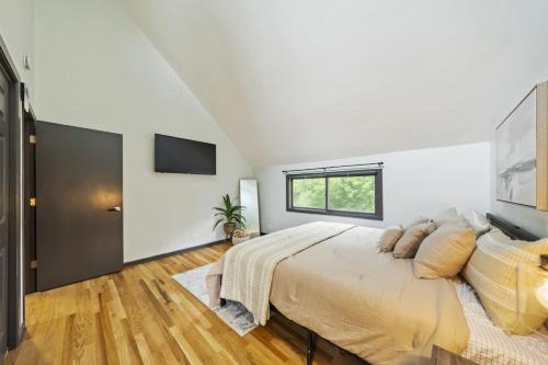a bedroom with a large bed and a television at New Year Spot- Navy Graduation King bed pool table in Beach Park