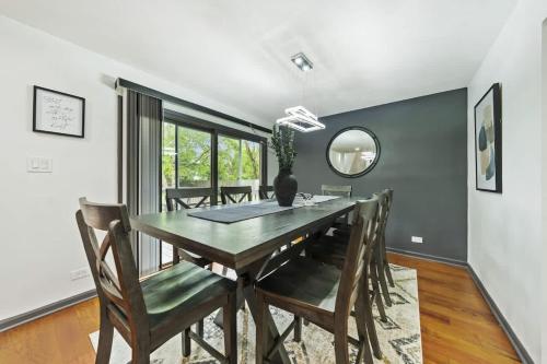 a dining room with a table and chairs and a mirror at New Year Spot- Navy Graduation King bed pool table in Beach Park