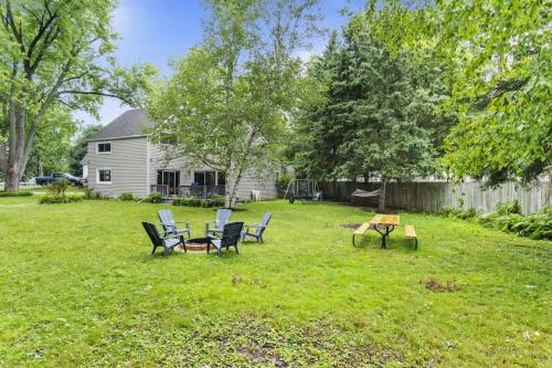 a yard with chairs and a table and a house at New Year Spot- Navy Graduation King bed pool table in Beach Park
