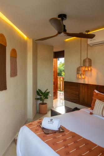 a hotel room with a bed and a room at Mantra Hotel Boutique in Puerto Escondido