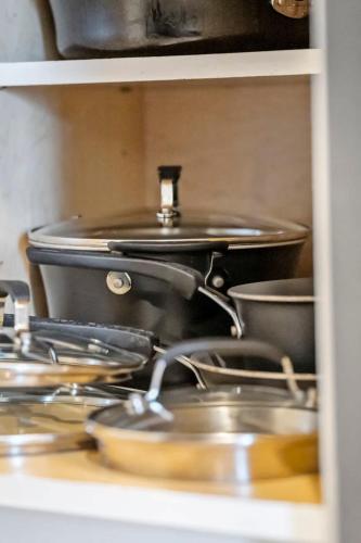 a bunch of pots and pans sitting on a stove at Bolingbrook King Bed 7 min to Hwy & Mall in Bolingbrook
