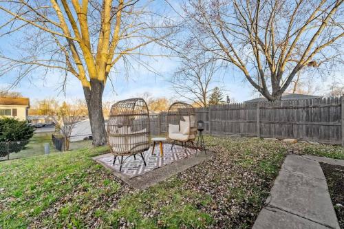 two bird cages in a yard with a fence at Bolingbrook King Bed 7 min to Hwy & Mall in Bolingbrook