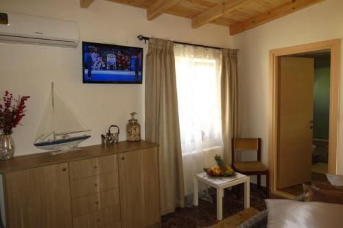 a living room with a boat on the wall at Unique Apartment'KONAKI' in Archanes